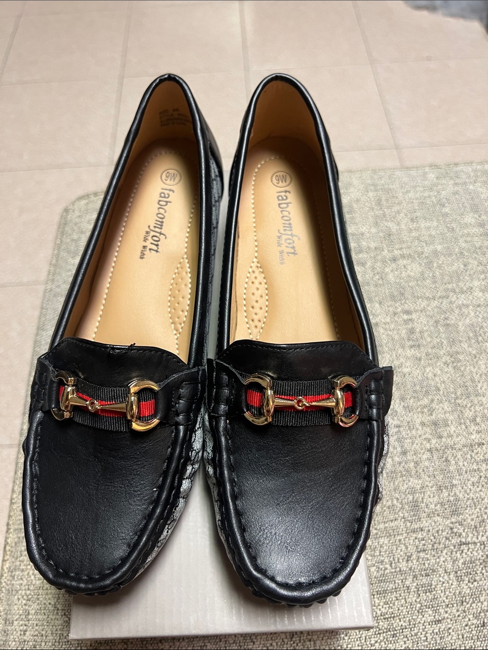 Labcomfort black leather loafers with gold stirrup detail